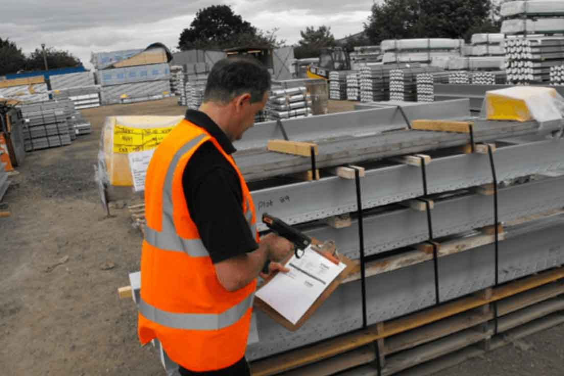 Taylor Wimpey Logistics is live on Sage X3 - Man in high viz vest scanning a document