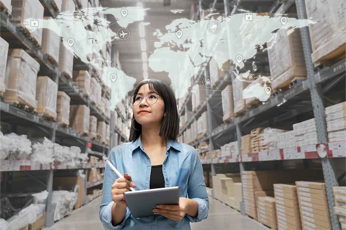 Woman in warehouse with map of world above her