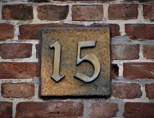 Number 15 on a brick wall