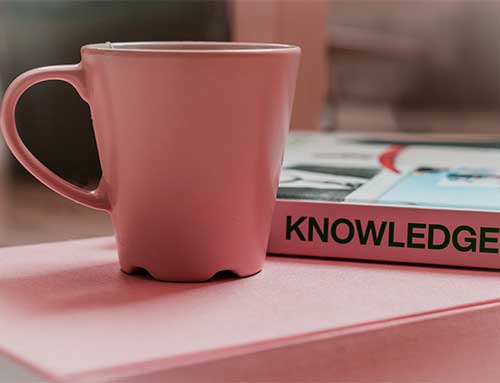 Sage X3 know-how - a pink mug with a pink book called 'knowledge'.
