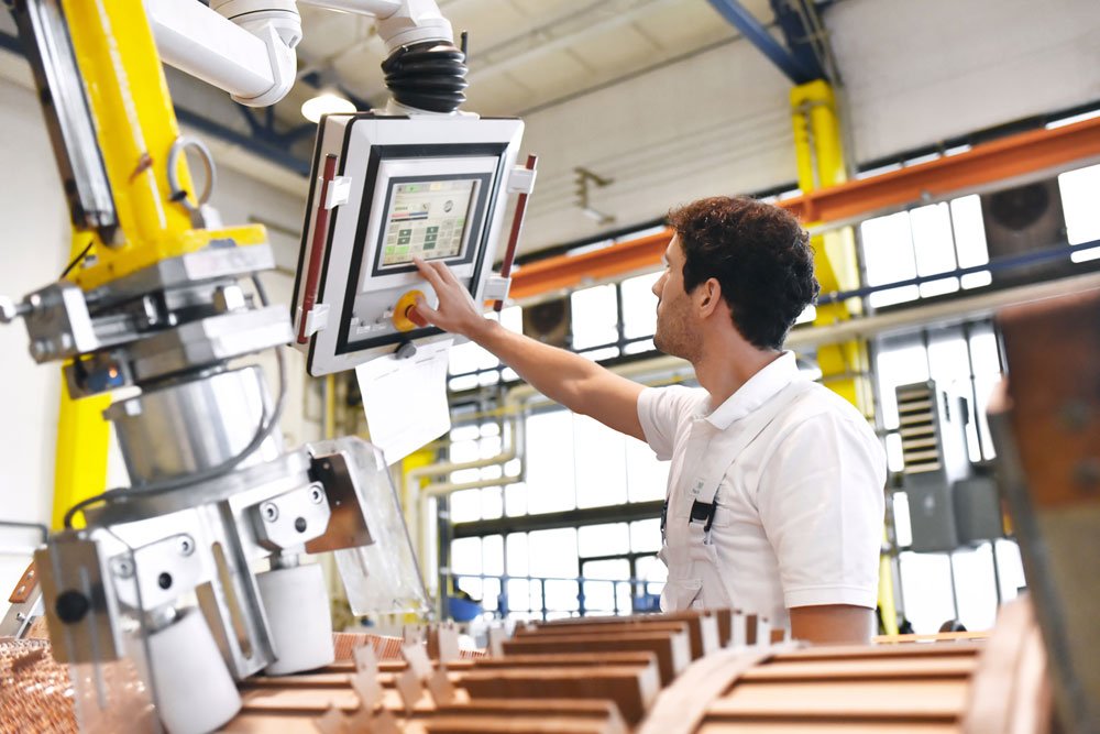 Sage X3 for manufacturing - factory worker using a screen