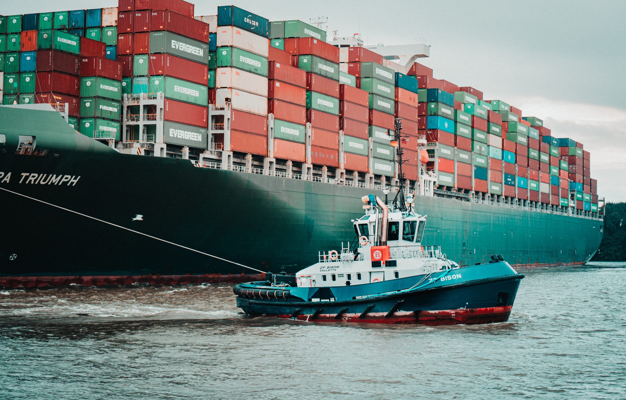 ERP for Supply Chain Management - container ship pulled by a tugboat