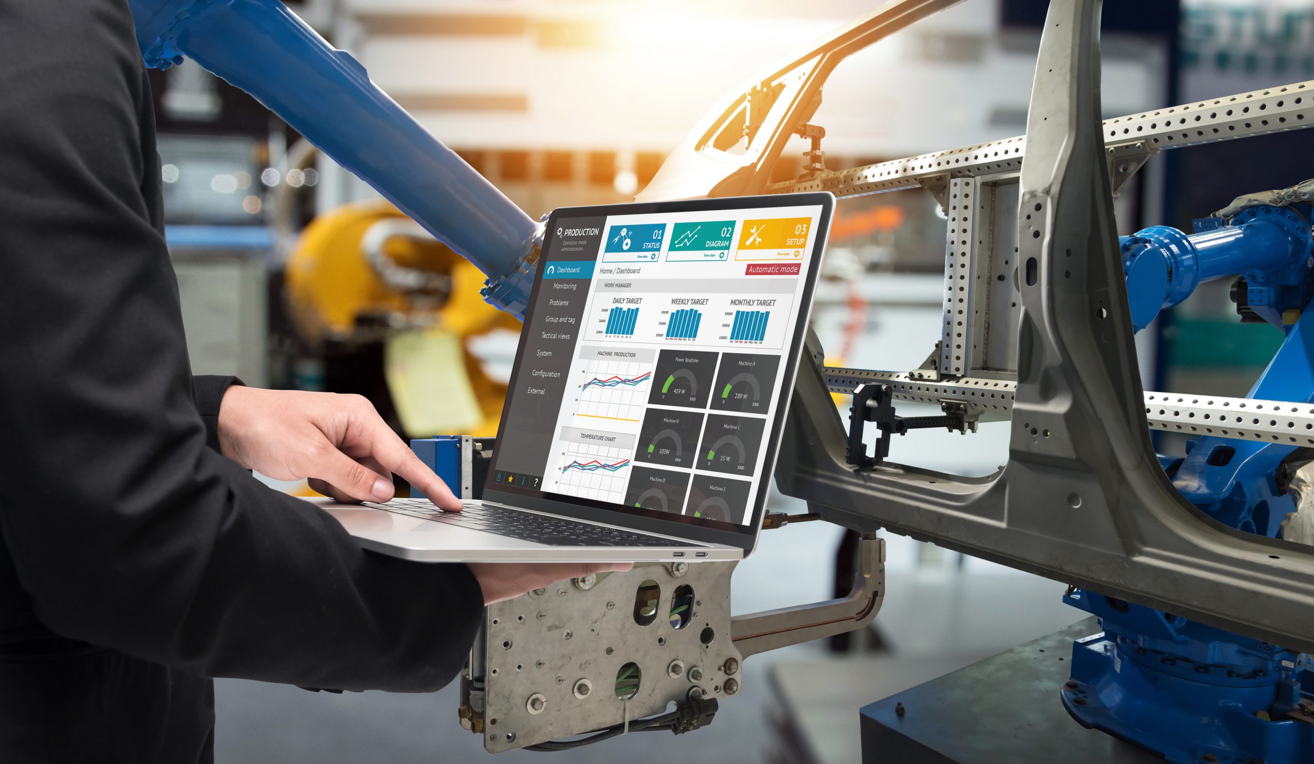 Manufacturing ERP solution - factory worker checking screen on laptop