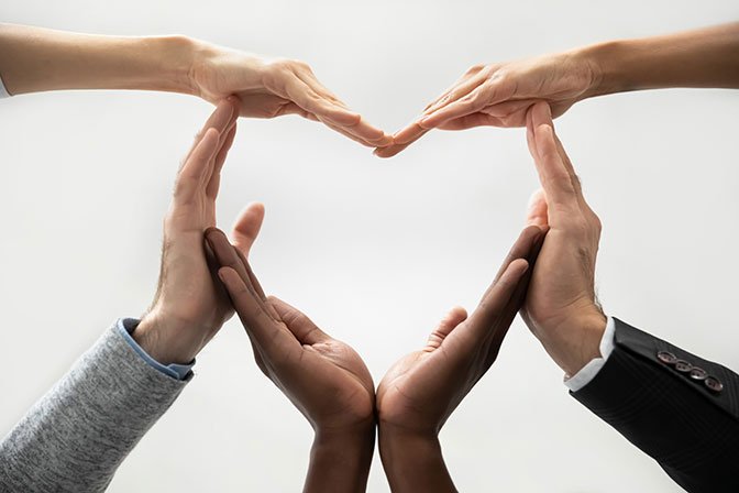 Mutual value - ERP - image of several hands making a heart.