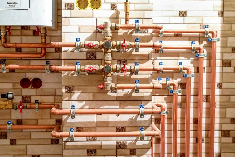 Talon-Manufacturing-pipes Collection of copper pipes on wall