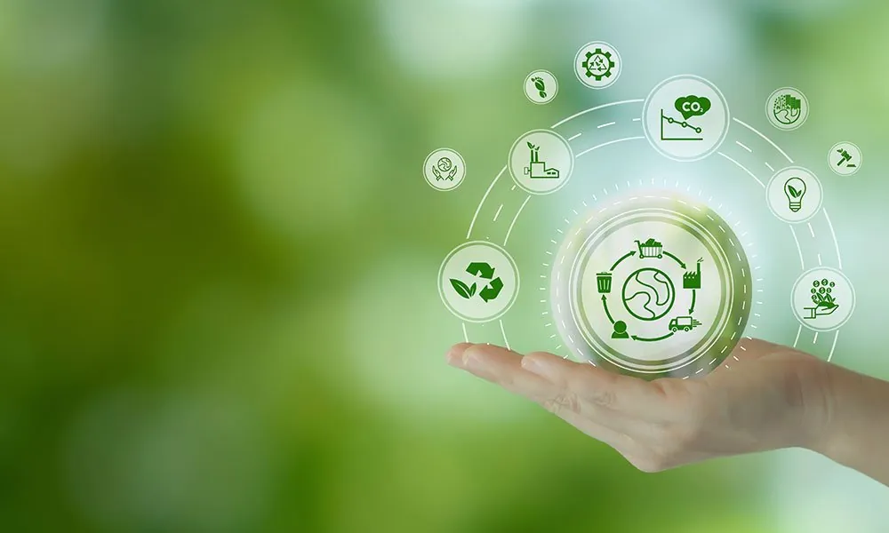 Manufacturing sustainability: Hand holding icons against a green background