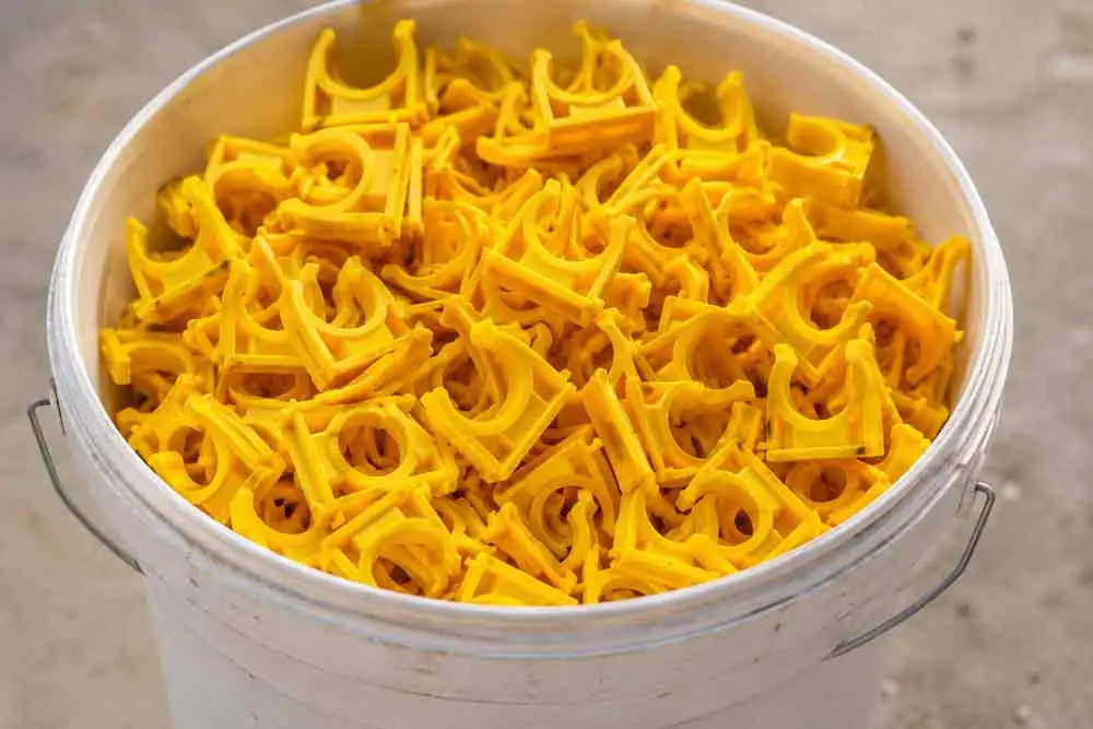 Talon-Manufacturing—bucket Bucket of yellow pipe clips